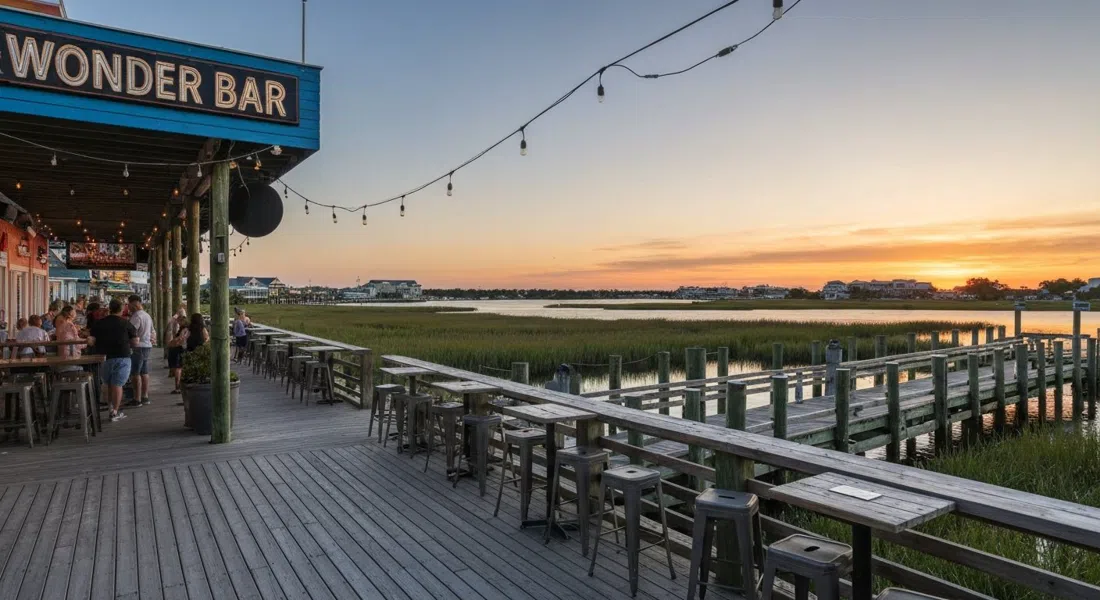 El muelle y la terraza al atardecer en Wonder Bar en Sunset Avenue, Atlantic City, con asientos de bar tiki y luz de pantano sobre la bahía trasera